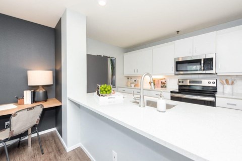 a kitchen with a large counter top and a sink