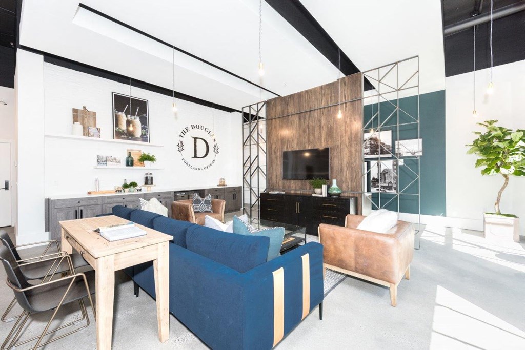 a living room with a blue couch and a table