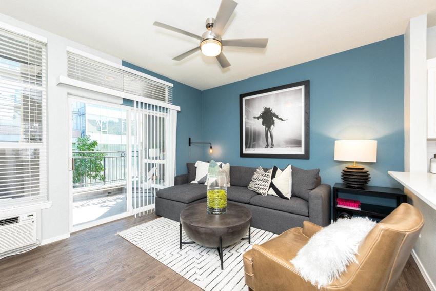 a living room with a couch and a ceiling fan