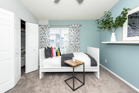 a bedroom with a bed and a window