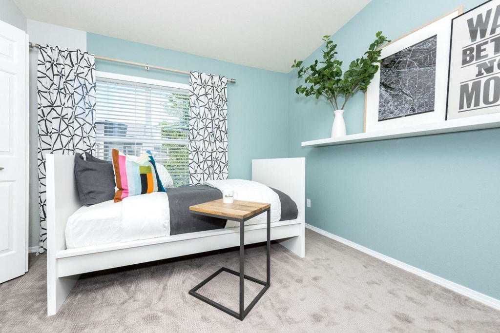 a bedroom with a bed and a window