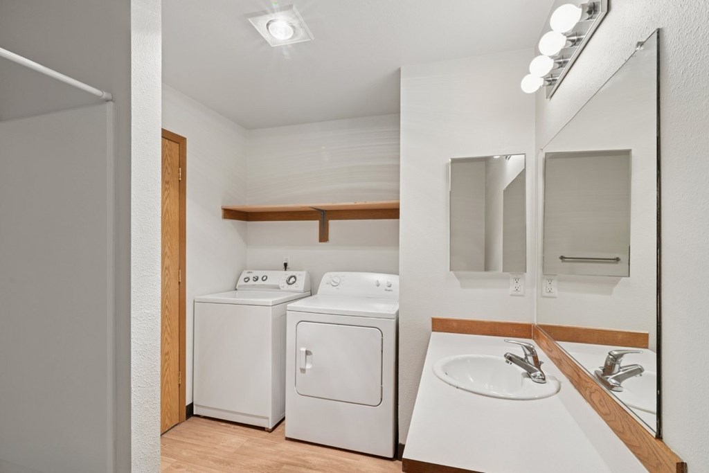A small bathroom with a washer and dryer.
