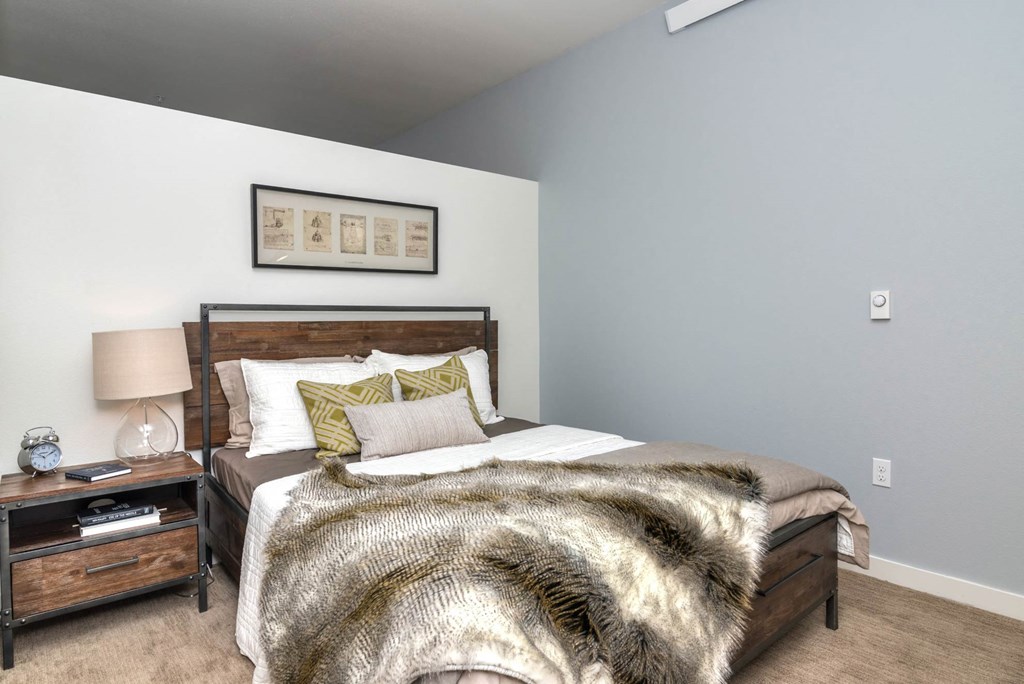 a bedroom with a bed and a nightstand