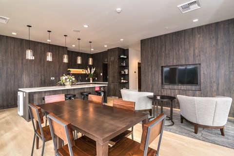 A modern dining room with a wooden table and chairs.