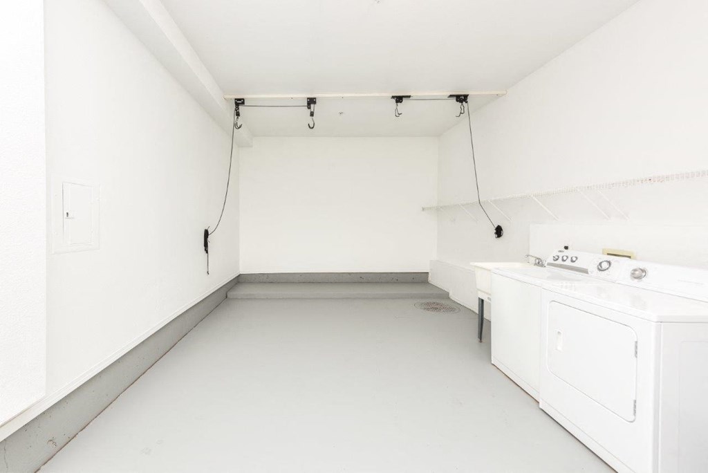 a white kitchen with white appliances and white walls