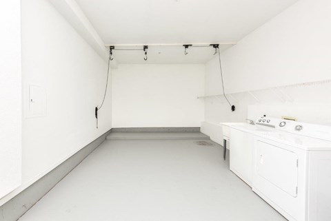 a white kitchen with white appliances and white walls