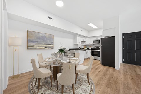 A modern dining room with a round table set for six.