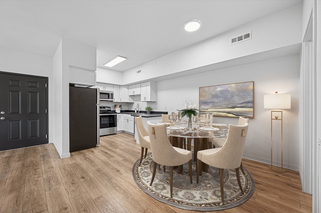 A modern kitchen with a dining table set for four.