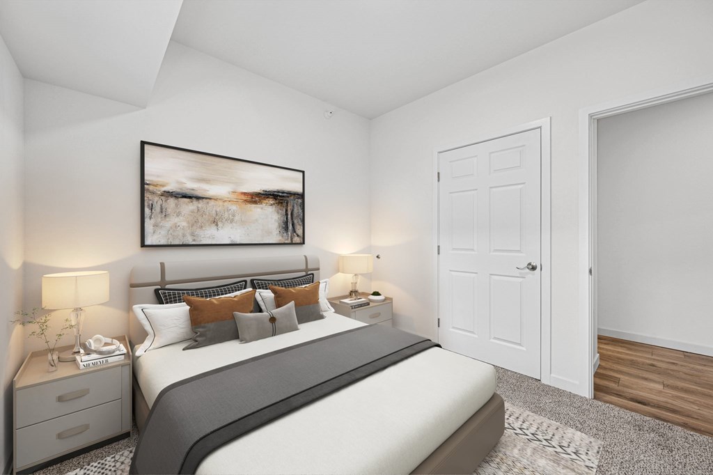 A bedroom with a large bed, nightstands, and a painting on the wall.