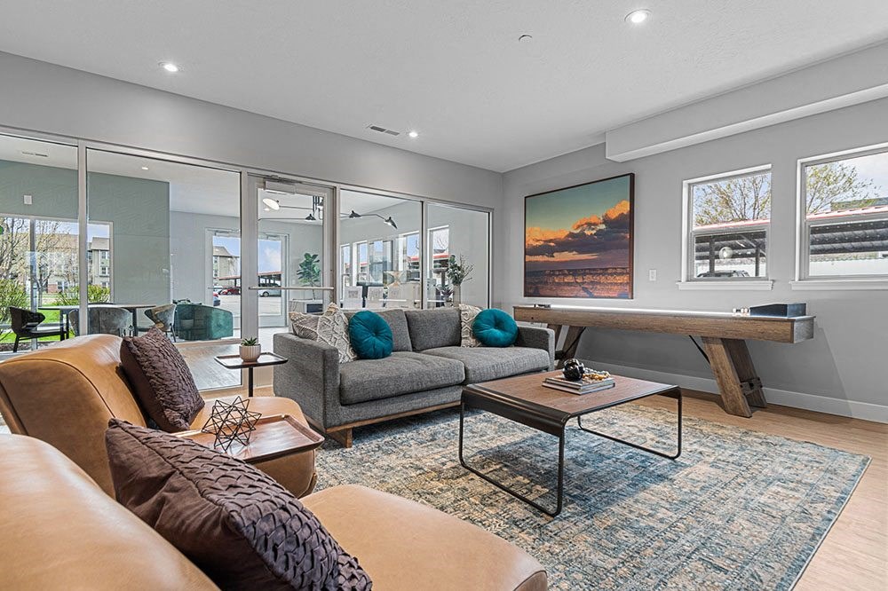 a living room with a couch coffee table and a ping pong table