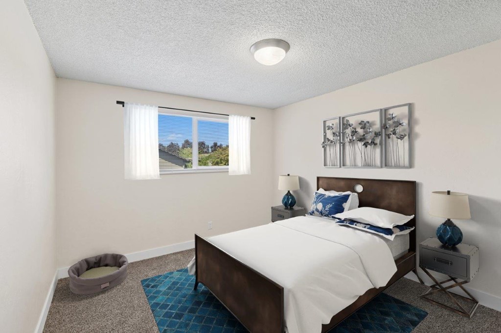 A bedroom with a large bed and a dog bed.