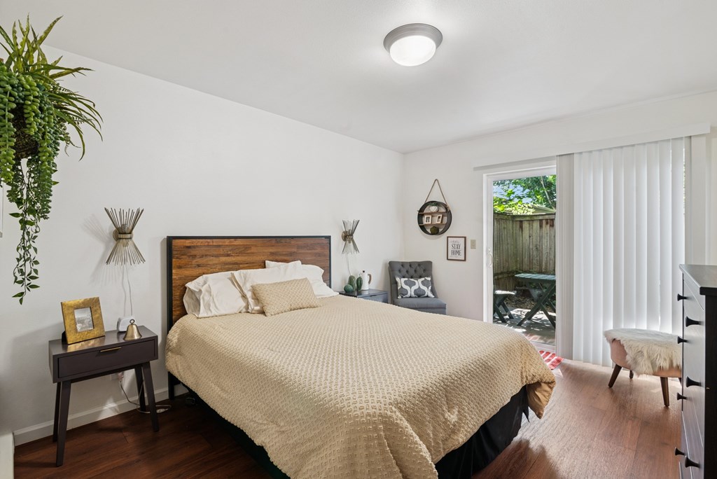 A bedroom with a large bed and a wooden headboard.