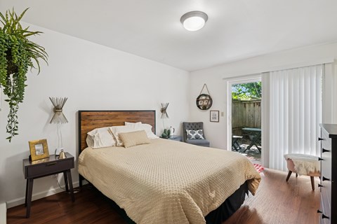 A bedroom with a large bed and a wooden headboard.