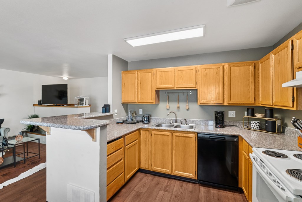A kitchen with wooden cabinets and black appliances.