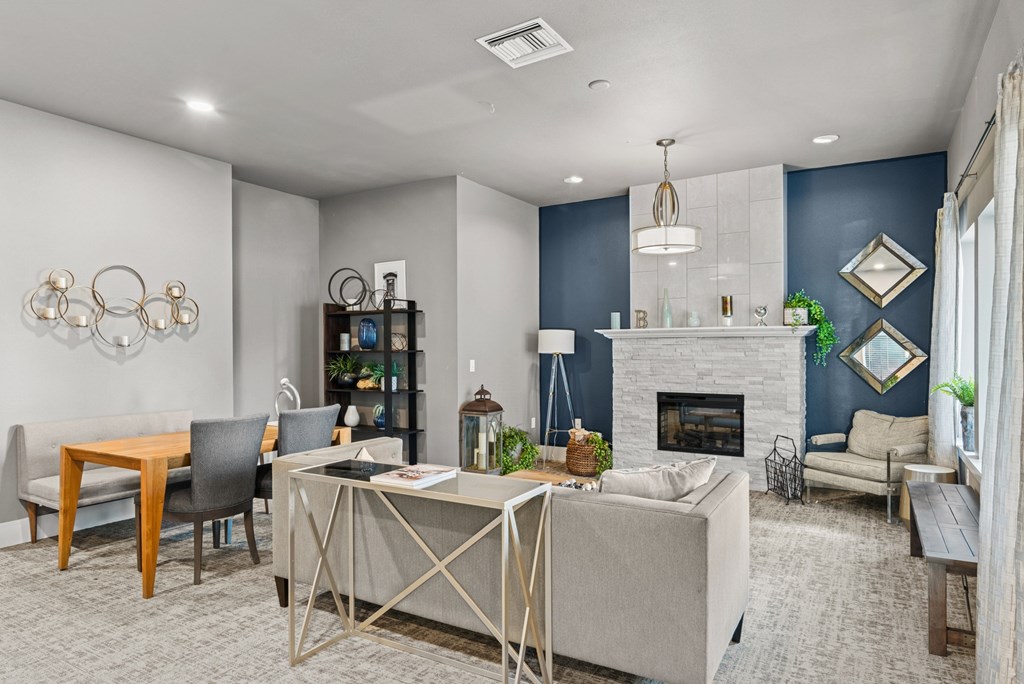 A modern living room with a fireplace and a dining table.