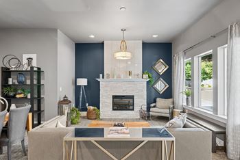 A modern living room with a fireplace and a dining table.