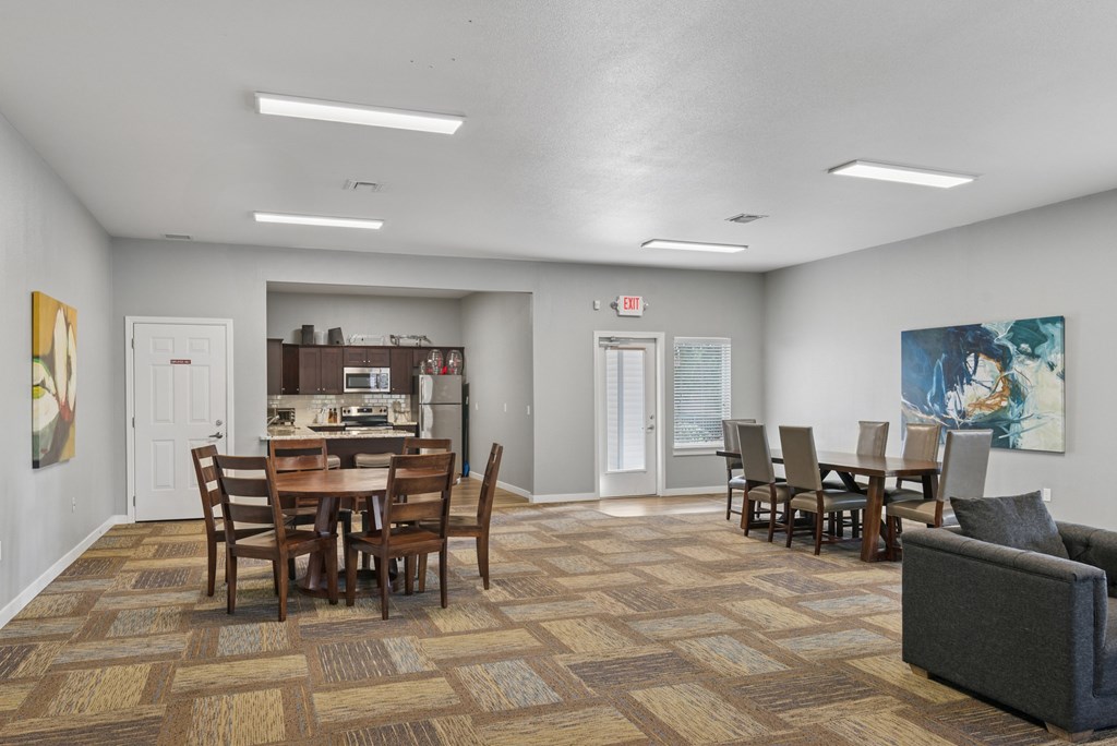 A dining room with a table and chairs.