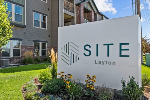a sign that says site layton in front of a building