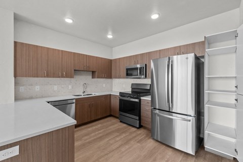 a kitchen with stainless steel appliances and wooden cabinets