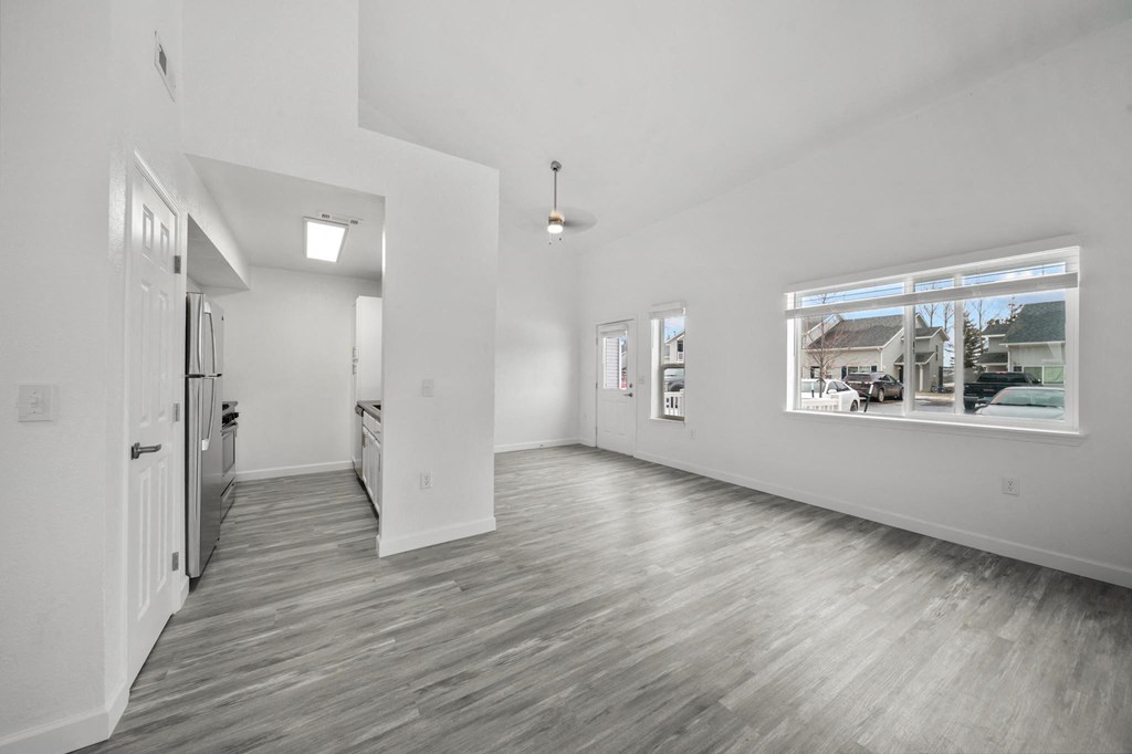 an empty room with a large window and white walls