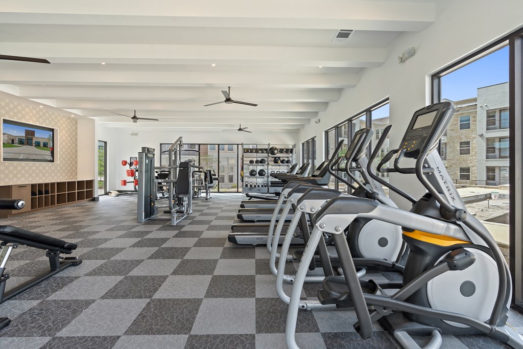 A gym with treadmills and other exercise equipment.