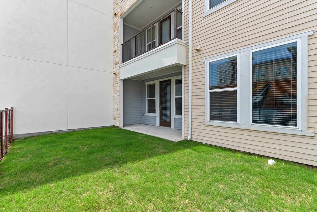A balcony with a railing is on the second floor of a house.