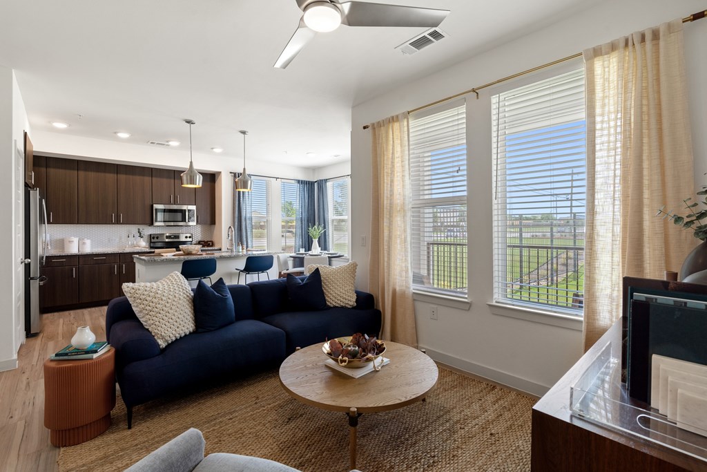 A living room with a blue couch and a television.