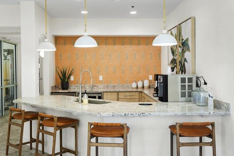 a kitchen with a counter top and some chairs