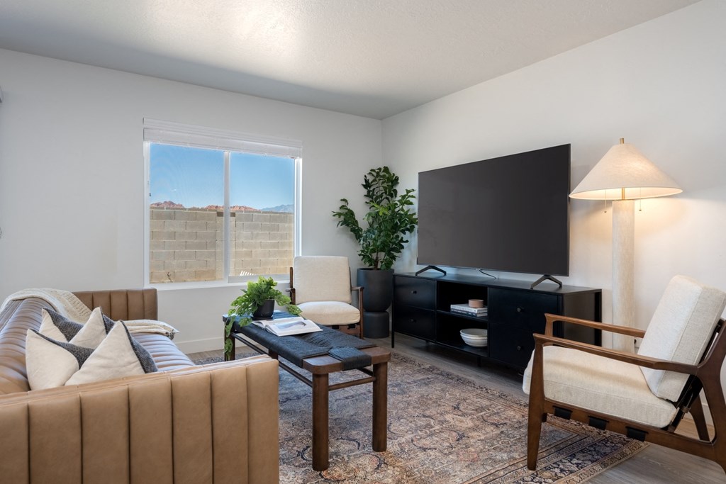 Desert Village Townhomes living room with a couch and a tv