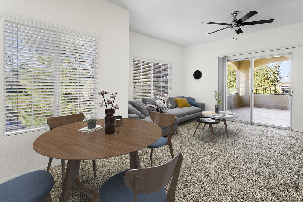 the living room of an apartment with a dining table and a couch