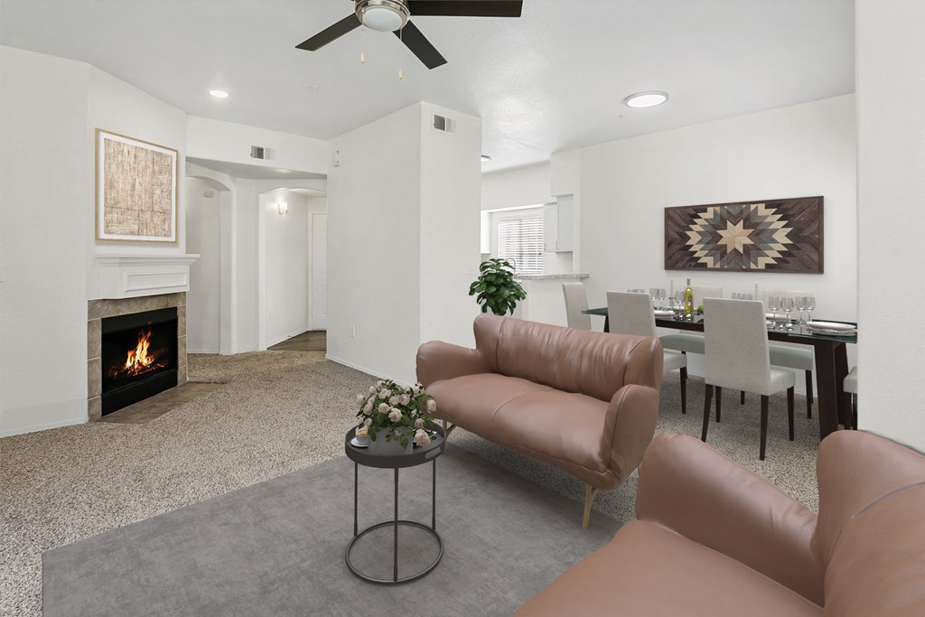 a living room with couches and a table and a fireplace