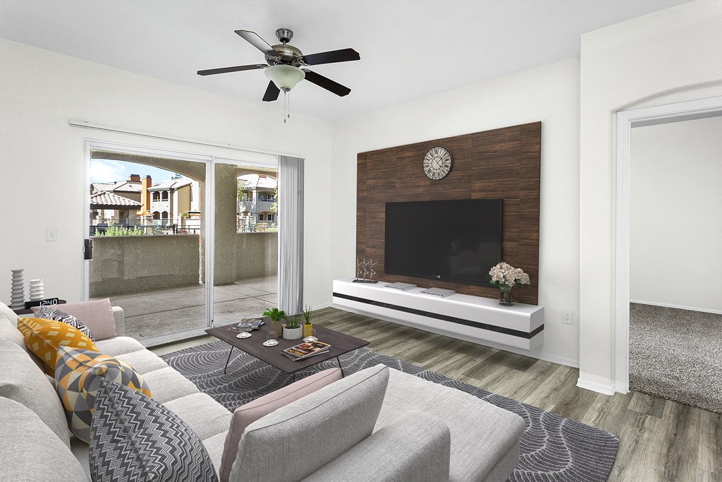 a living room with a fireplace and a ceiling fan