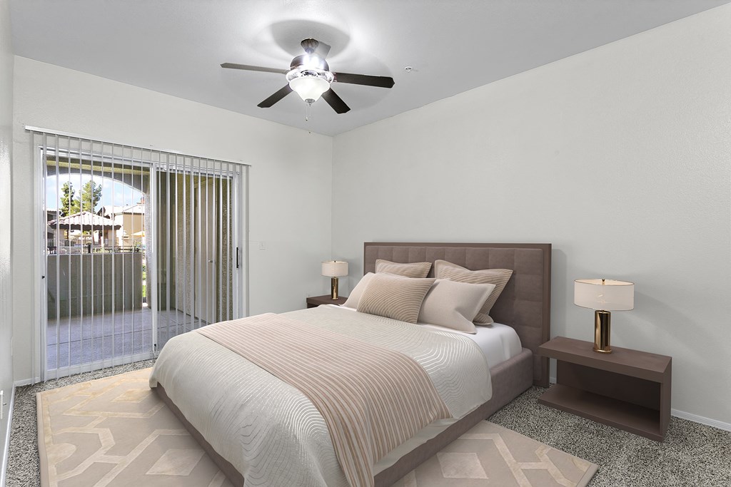 a bedroom with a bed and a ceiling fan