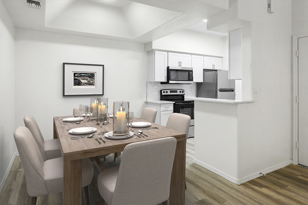 a kitchen and dining room with a table and chairs