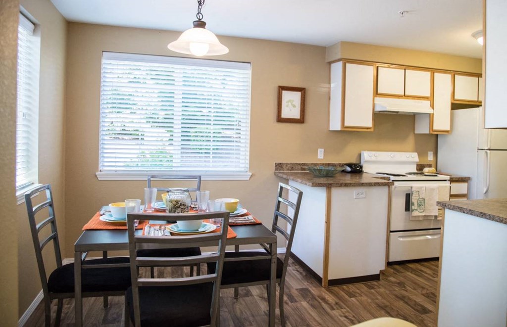 a kitchen and dining room with a table and chairs
