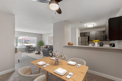 a dining room and living room with a table and chairs