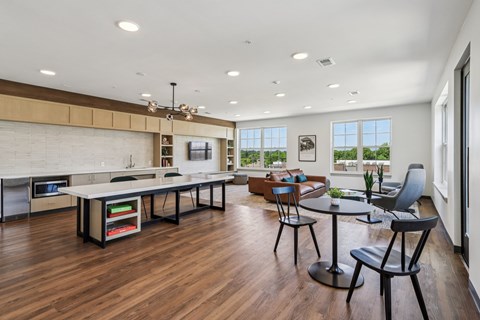 A modern kitchen with a dining table and chairs.