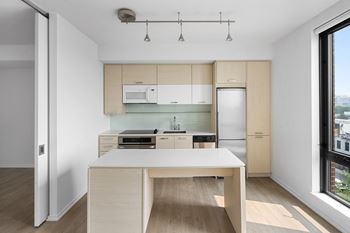 a kitchen with a white island and wooden cabinets