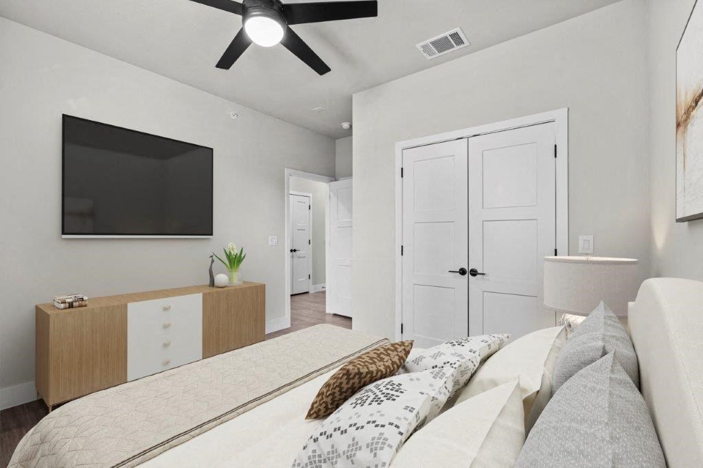 a bedroom with a large bed and a tv