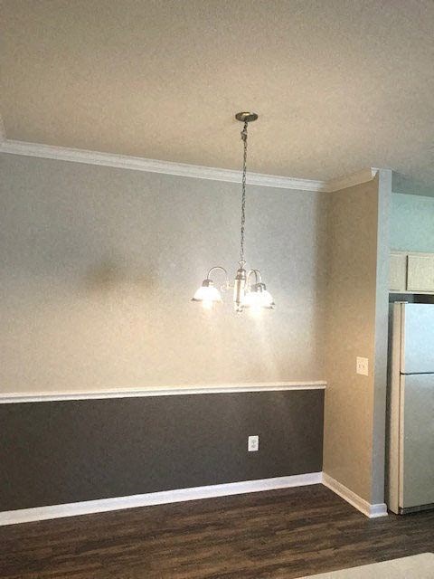 a living room with two lights and a refrigerator