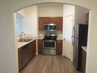 a kitchen with stainless steel appliances and wooden cabinets