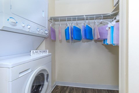 A laundry room with a washer and dryer and a sign that says "Laundry Its Load of Fire".