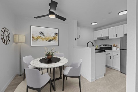 an open kitchen and dining room with a table and chairs