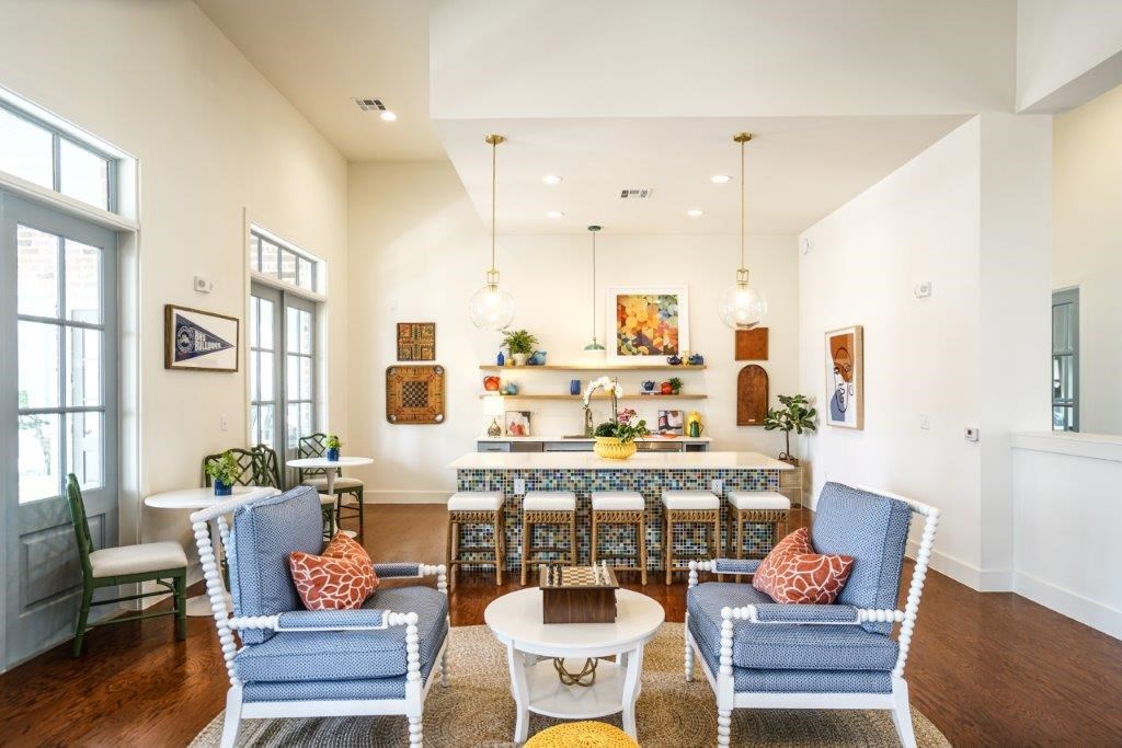 A living room with a blue chair and a white chair.