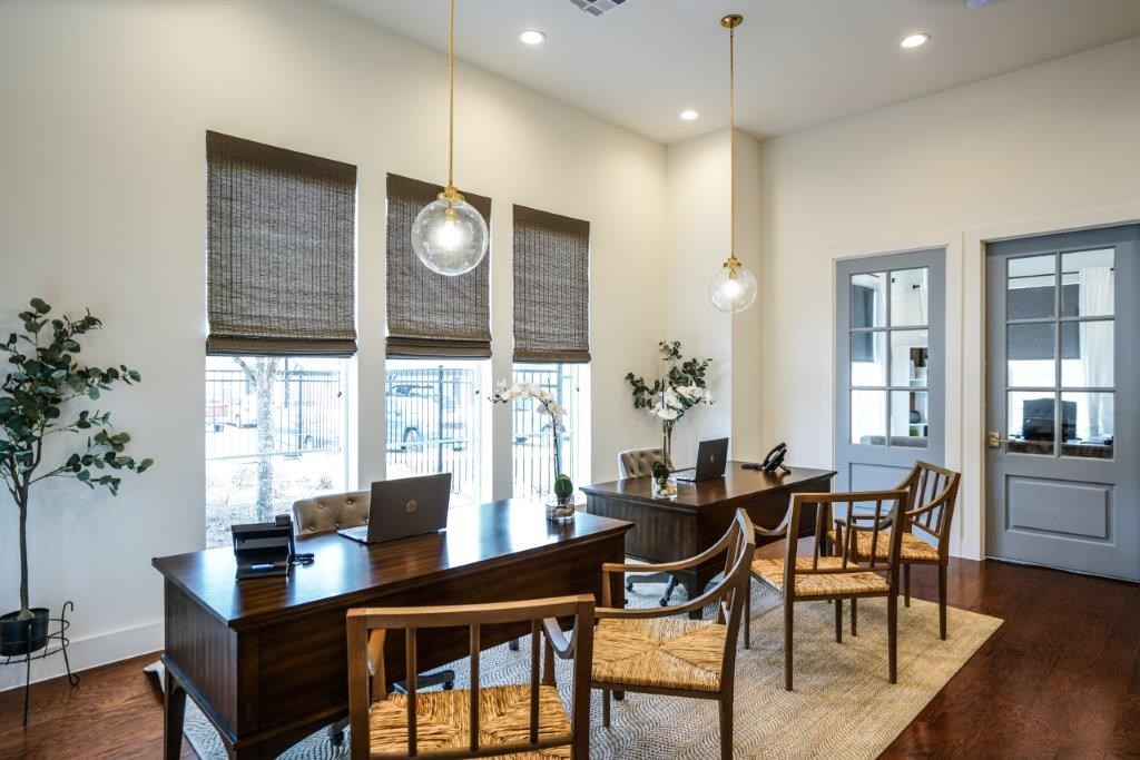 A dining room with a wooden table and chairs.