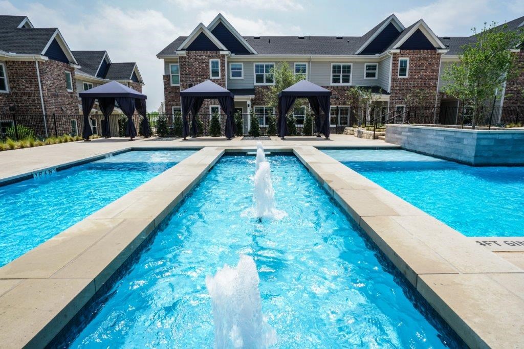 A large pool with a waterfall in the middle of it.