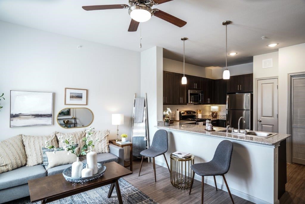A modern kitchen with a dining table and chairs.