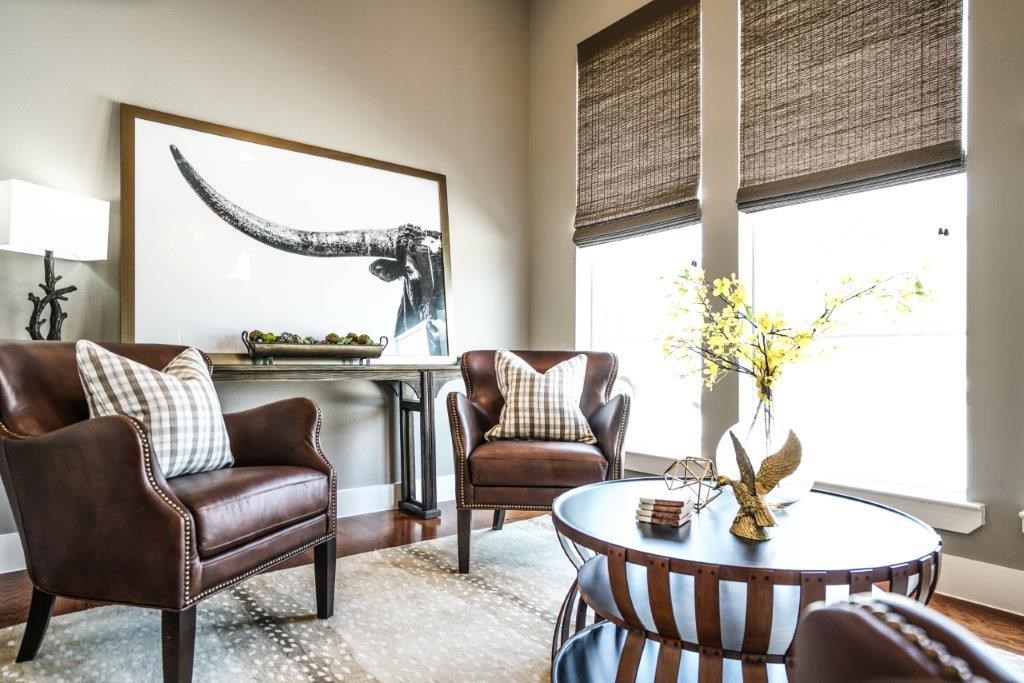 A living room with a large painting of a whale above a table.
