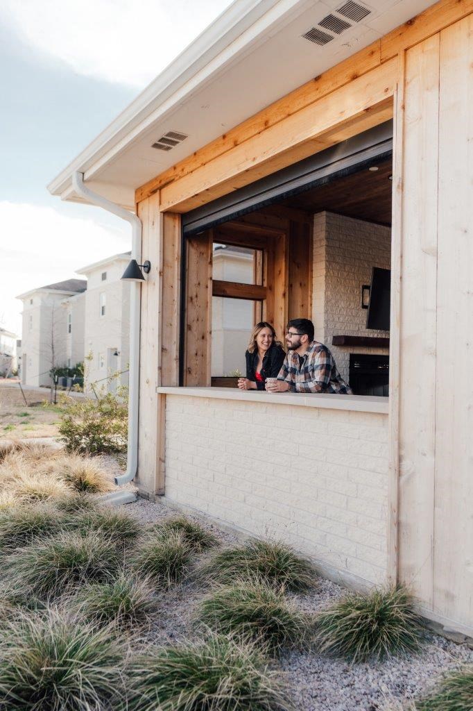 Man and Woman Smiling and Talking with Each Other while Standing in Lounge Area at Emerson at Leander