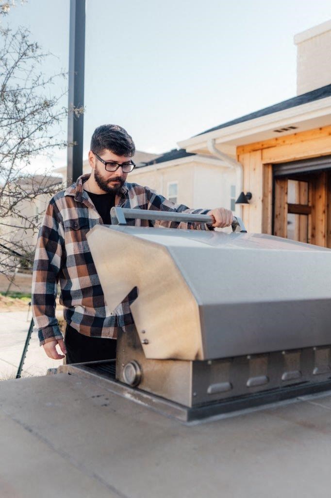 Man Looking at BBQ Grill at Emerson at Leander